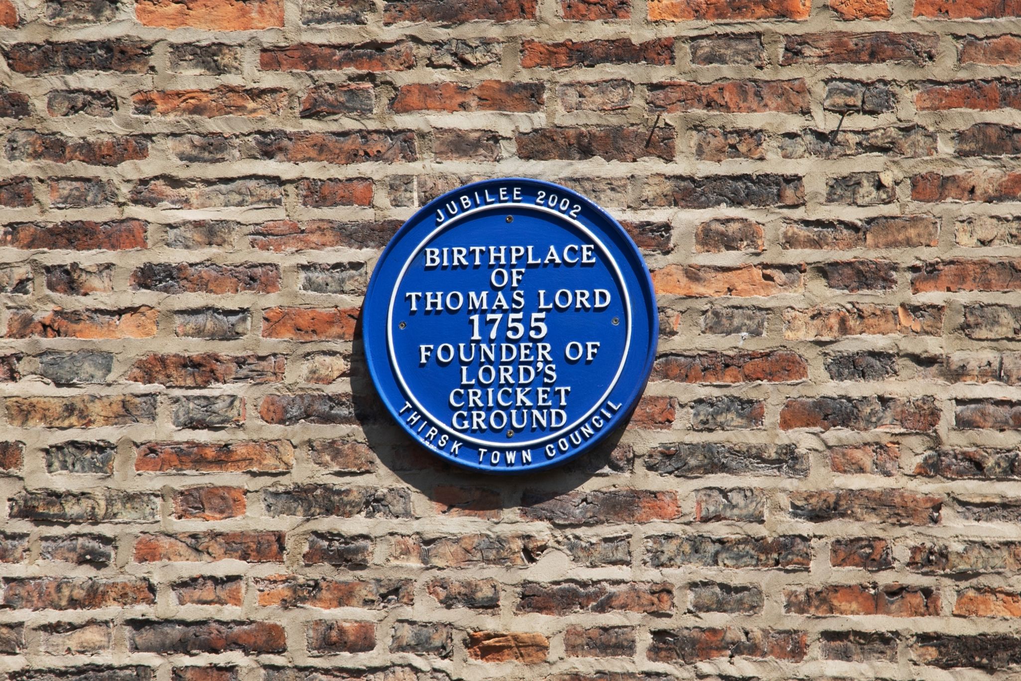 Blue plaque oh home showing historical significance